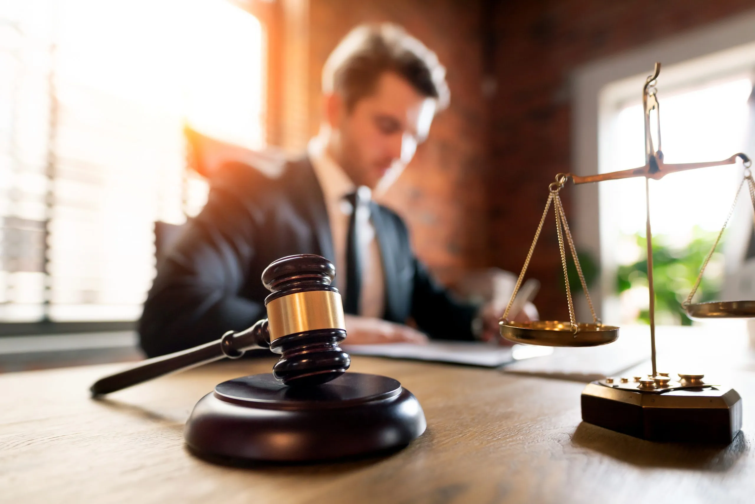 Gavel and scales in legal office.
