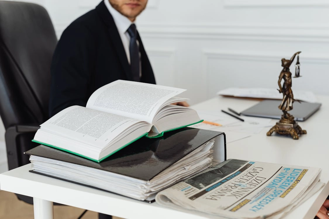 Legal documents and a newspaper on desk