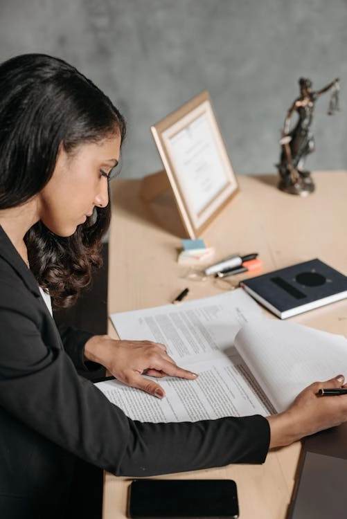 Person reviewing documents at desk.