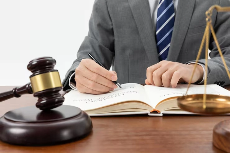 Lawyer writing in legal book