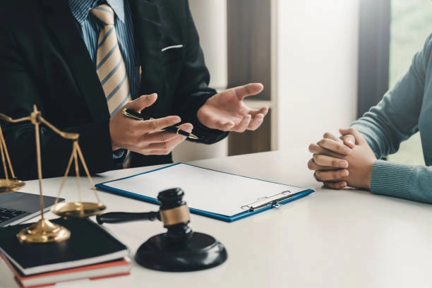 Lawyer consulting with client at desk