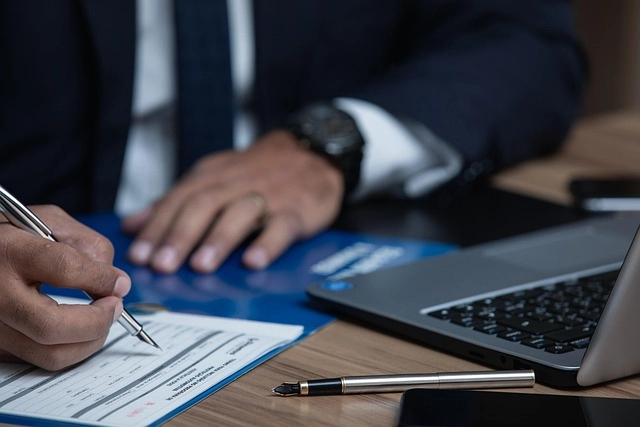 Businessman signing documents at desk