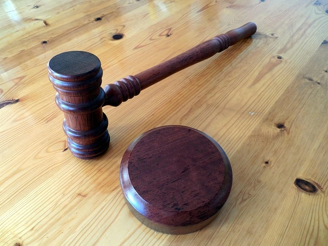 Wooden gavel and sound block on table