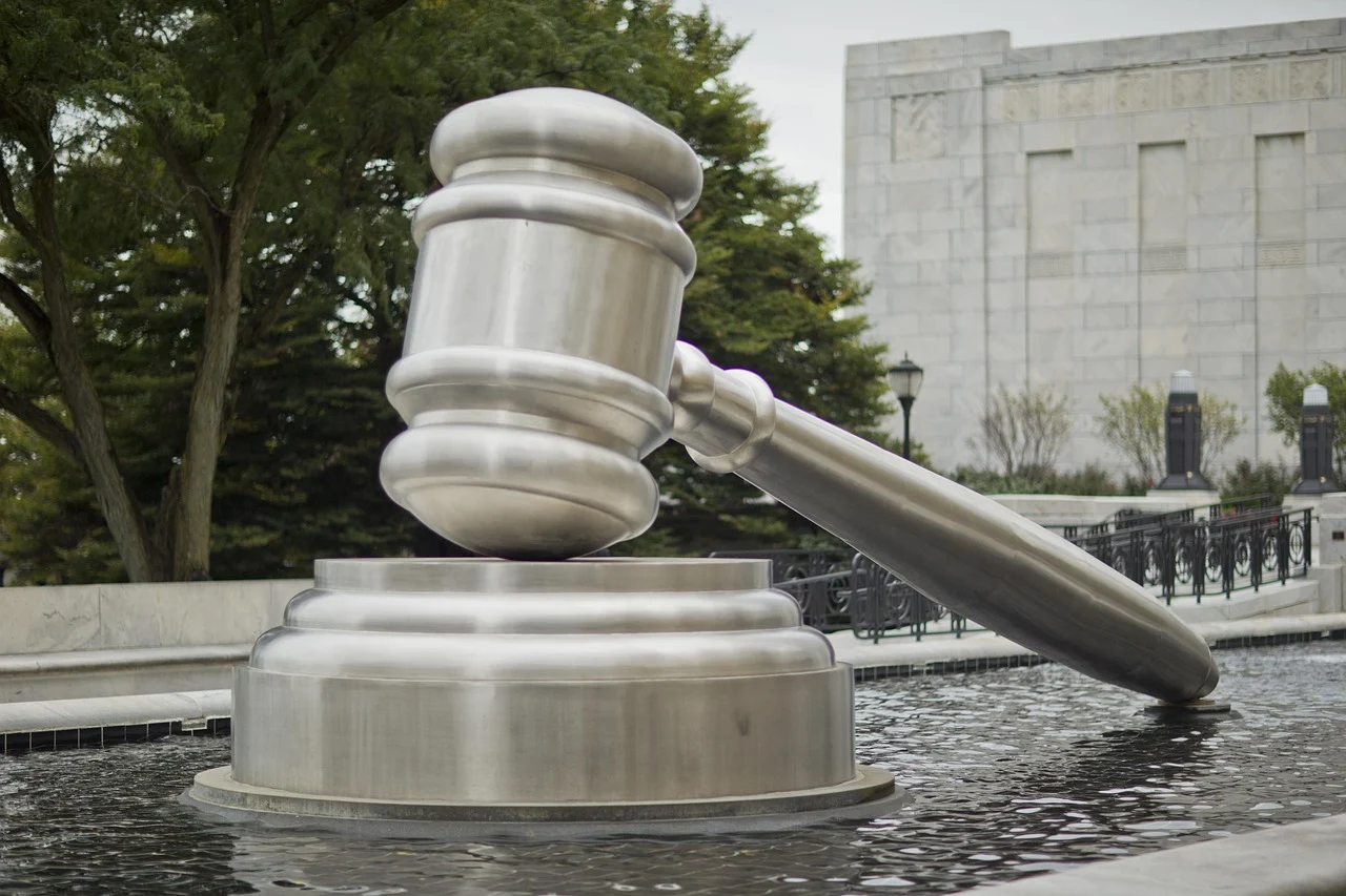 Large metallic gavel in water