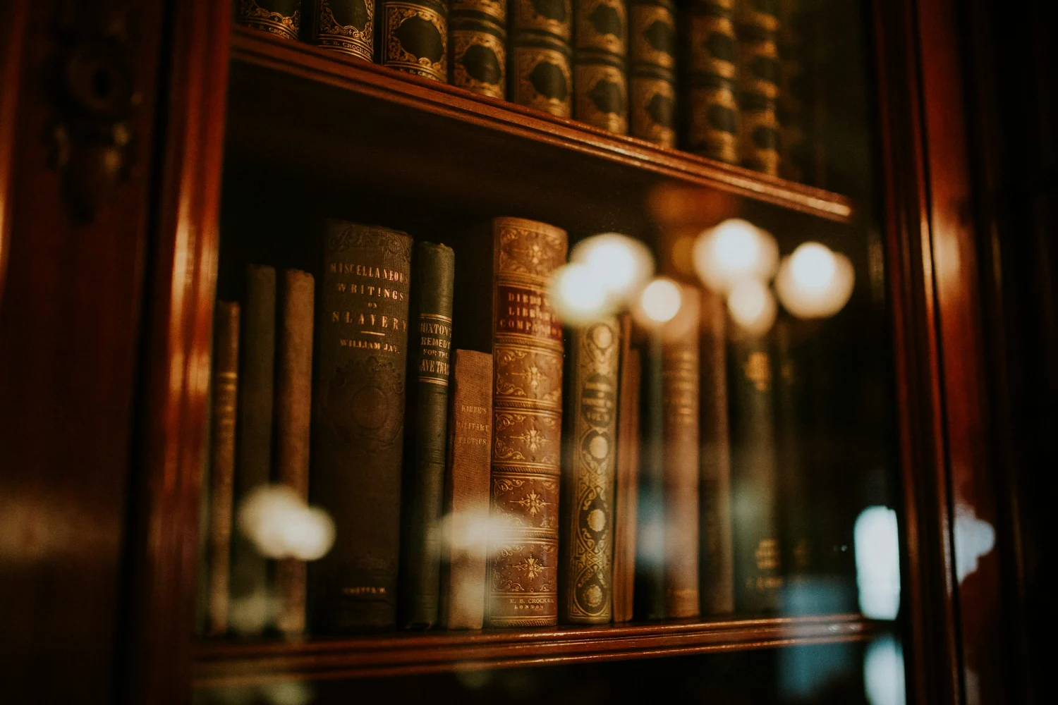 Old books in a wooden cabinet