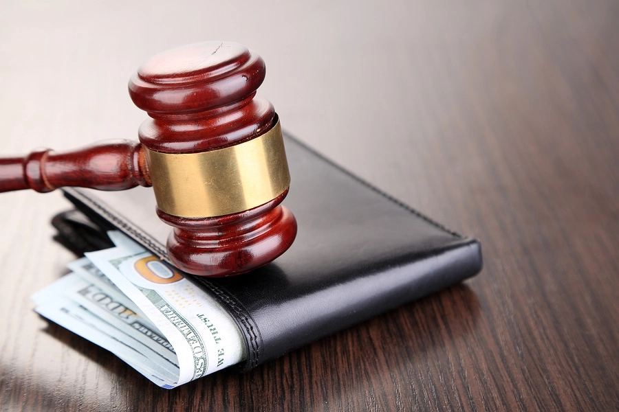 Gavel resting on a wallet.
