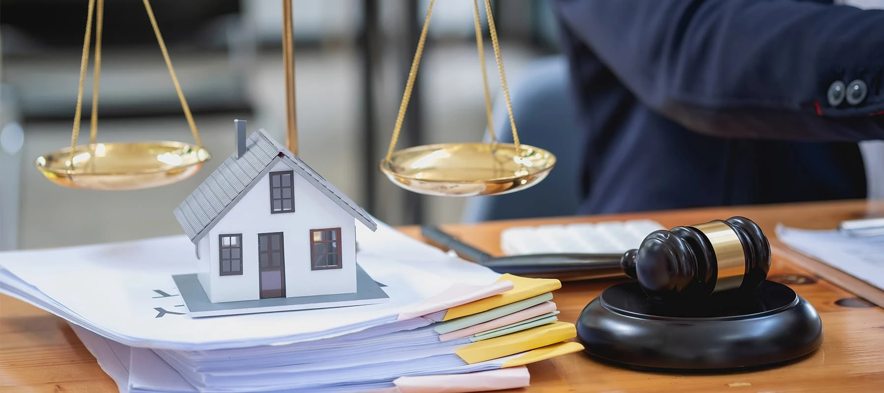 Legal scales with house model and gavel